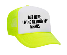 Load image into Gallery viewer, Out Here Living Beyond My Means Trucker Hat
